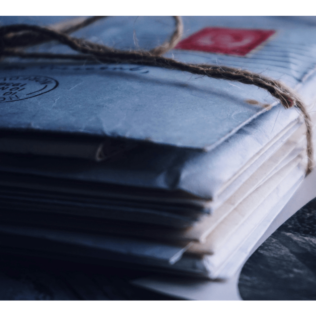 a stack of tattered letters tied together with twine